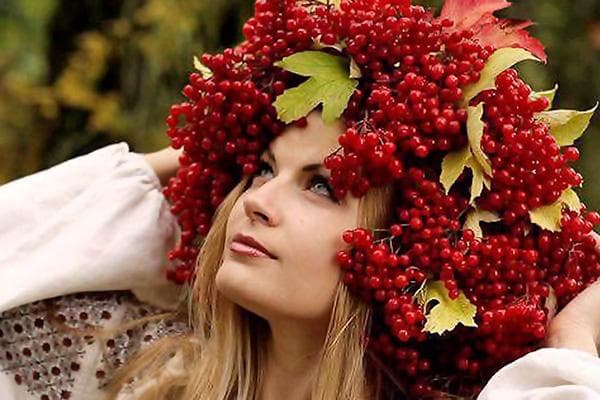 Frau mit einem Kranz aus Schneeballbeeren und -blättern