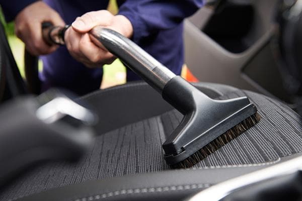 Reinigung des Autos mit dem Staubsauger