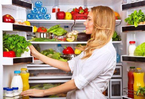 junge Frau am Kühlschrank