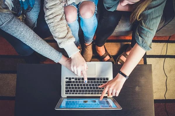 Junge Frauen kaufen im Online-Shop ein.
